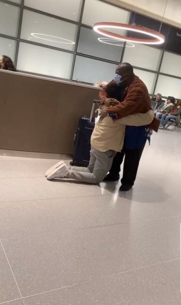 Mathew kneeling in awe as Dr. Andrew Solomon receives him at the airport