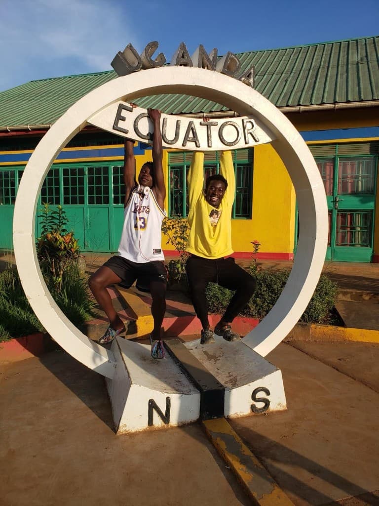 Mathew and his best friend Kyambadde Samson at the Equator