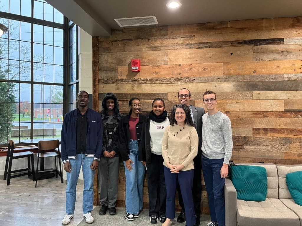 Mathew with students, friends, his mentor Mr. Jesse, his wife Krista, and his son