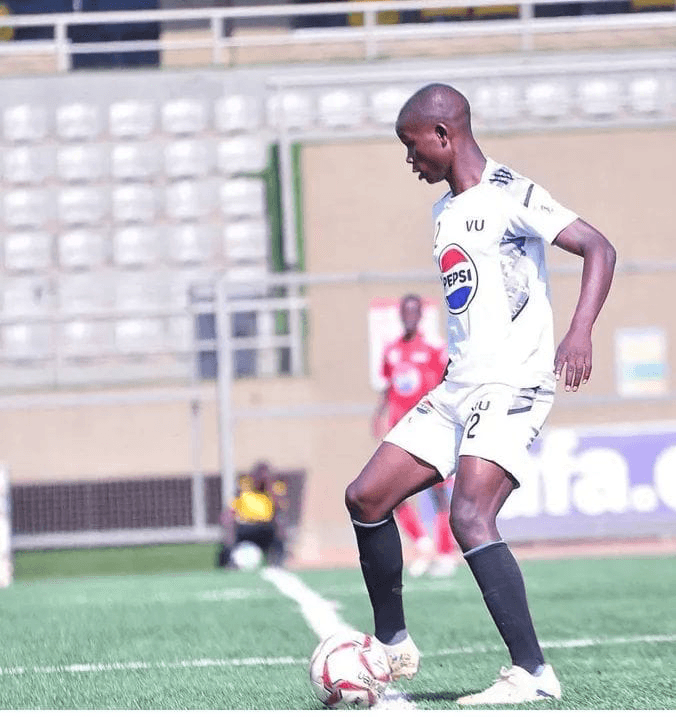 Samson playing soccer in his Victoria University jersey